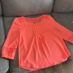 cute vibrant coral colored blouse. cute see through wrists and top.